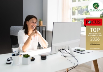 Frau sitzt vor Computer und schaut sich eine Vorlesung an